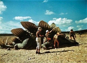 The boys investigate a recently killed Stegosaurus in Karel Zeman's Journey to the Beginning of Time (1955)