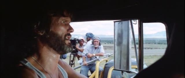 Sam Peckinpah (background) in his cameo as a TV news director in Convoy