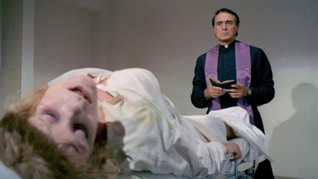 Father Michael (Robert Alda) confronting the possessed Lisa (Elke Sommer) in House of Exorcism (1975)