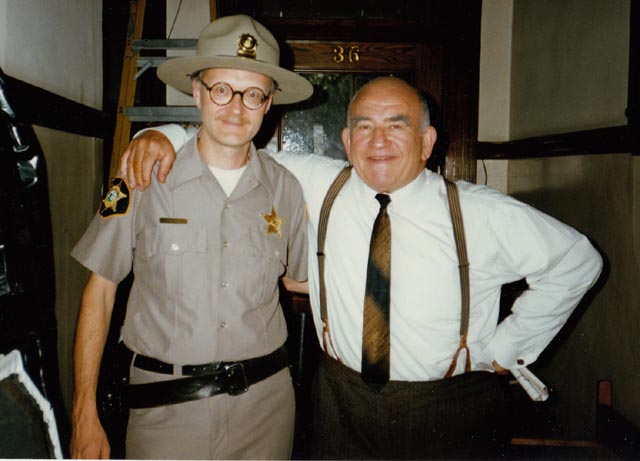 Yes, that's me, the least convincing state trooper ever to appear on screen, hanging out with the very affable Ed Asner on the set of Paul Shapiro's Heads (1994)