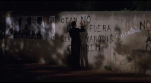 Fred (Chris Eigeman) attempts ineffectually to erase anti-American graffiti with a marker in Whit Stillman's Barcelona (1994)