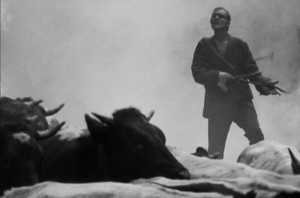 Dragon (Radovan Lukavský) leads the village herd out of the burning forest in Eduard Grecner's Dragon's Return (1968)