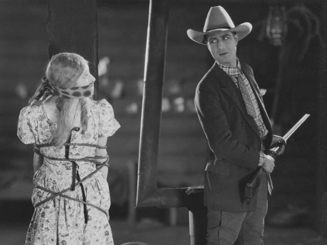 Mae and Julian in a classic silent film situation in Anthony Asquith's Shooting Stars (1928)