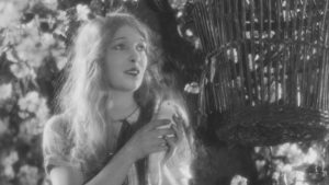 Mae about to be pecked by her pet dove in Anthony Asquith's Shooting Stars (1928)