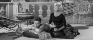 Cliff Richard as Bongo Herbert relaxes with Dixie Collins (Yolande Donlan) in Val Guest's satirical musical Expresso Bongo (1959)