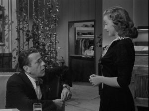 Dix Steele invites hatcheck girl Mildred home to tell him the plot of a novel in Nicholas Ray's In a Lonely Place (1950)