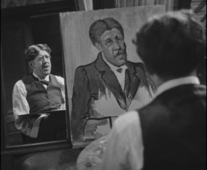 Maurice Legrand (Michel Simon) works on his self-portrait in Jean Renoir's La Chienne (1931)