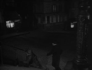 On his way home Maurice Legrand (Michel Simon) sees the pimp Dede Georges Flamand) striking Lulu (Janie Marese) in Jean Renoir's La Chienne (1931)