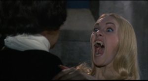One of the Karnstein brood about to put the bite on Baron von Hartog in Roy Ward Baker's The Vampire Lovers (1970)