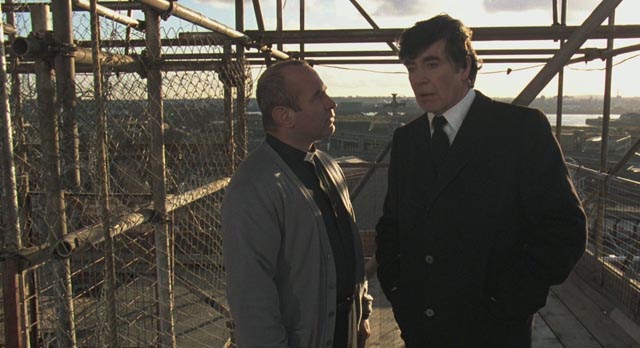 Gangster Jack Meehan (Alan Bates) threatens Father Michael (Bob Hoskins) in Mike Hodges' A Prayer for the Dying (1987)