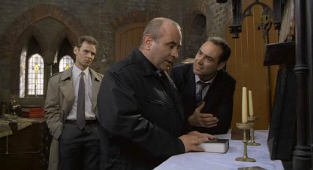 Father Michael Da Costa (Bob Hoskins) refuses to cooperate with the police in Mike Hodges' A Prayer for the Dying (1987)