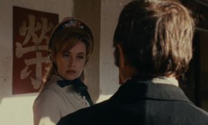 Virginie (Jeanne Moreau) approached on the street by Levinsky (Roger Coggio) in Orson Welles' The Immortal Story (1968)