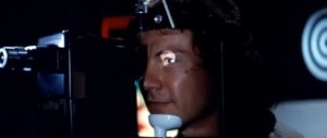 Roddy (Harvey Keitel) has a camera implanted in his eye in Bertrand Tavernier's Death Watch (1980)