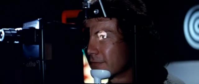 Roddy (Harvey Keitel) has a camera implanted in his eye in Bertrand Tavernier's Death Watch (1980)