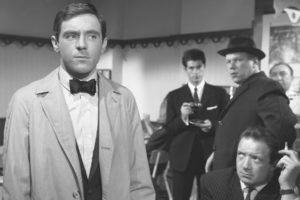 Sammy observed by the two enforcers sent to collect the debt in Ken Hughes' The Small World of Sammy Lee (1963)