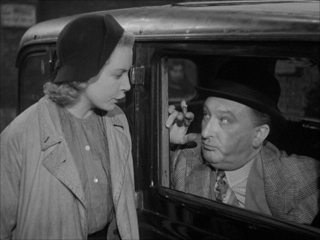 Sally (Deborah Kerr) is approached with an offer by shady businessman Sam Grundy (Frank Cellier) in John Baxter's Love on the Dole (1941)