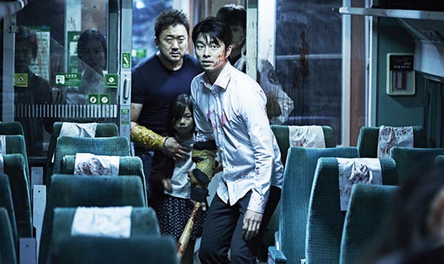 Seok Yoo (Yoo Gong) and Sang Hwa (Dong Seok-ma) trapped on the train in Yeon Sang-ho's Train to Busan (2016)