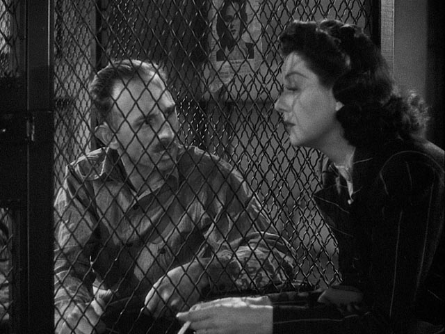 Hildy plays sympathetic to get an exclusive interview with condemned man Earl Williams (John Qualen) in Howard Hawks' His Girl Friday (1940)