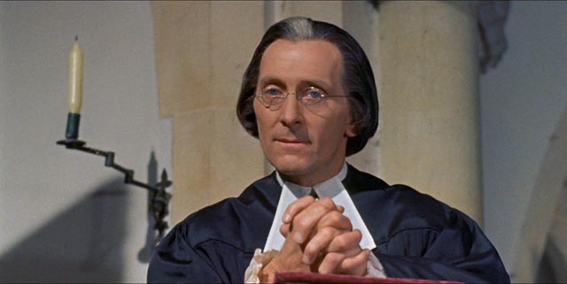Peter Cushing as Dr. Blyss, the village priest in Peter Graham Scott's Night Creatures (1962)