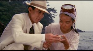The man in white enjoys an oyster with a virginal oyster fisher in Juzo Itami's Tampopo (1985)