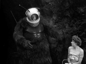 Ro-Man menacing one of the few survivors of an alien attack in Phil Tucker's Robot Monster (1953)