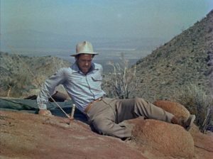 Robert Ryan as the resourceful Carson prepares to set his own broken leg in Roy Ward Baker's Inferno (1953)