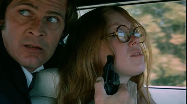 Student Sandra (Leslie Ann Rivers) and her abductor Eddie (Jack Canon) in Frederick R. Friedel's Kidnapped Coed (1975)