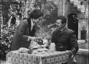 The teacher Ayse (Pervin Par) serves Lieutenant Zeki (Atilla Ergün) tea in Lütfi Akad's Law of the Border (1966)