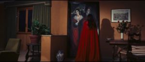 The apparently reincarnated Red Queen contemplates the sinister painting of the family curse in Emilio P. Miraglia's The Red Queen Kills Seven Times (1972)