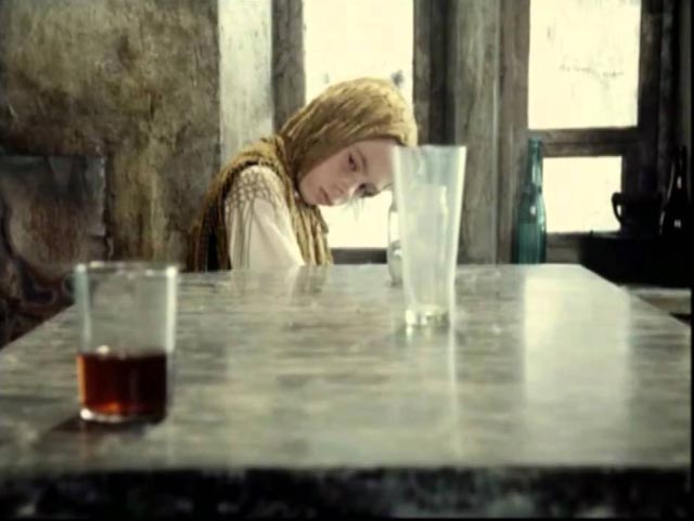 The Stalker's crippled daughter Monkey (Natasha Abramova) moves a glass across the table with her mind in Andrei Tarkovsky's Stalker (1979)