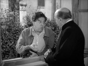 Braconnier complains about his marriage to the village priest (Jean Duvaleix) in Sacha Guitry's La poison (1951)