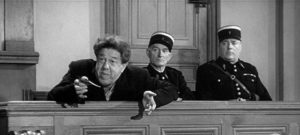 Braconnier (Michel Simon) argues that the law supports his act of murder in Sacha Guitry's La poison (1951)