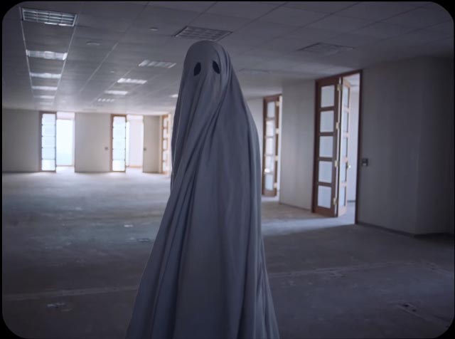 The ghost of C prowls through the building erected on the site of his demolished home in David Lowery's A Ghost Story (2017)