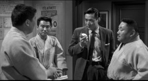 Detective Joe Kojaku (James Shigeta) seeks information Los Angeles' Japanese community in Samual Fuller's The Crimson Kimono (1959)