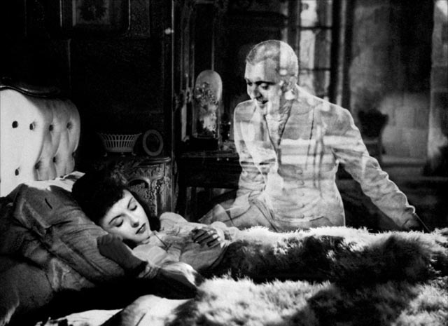 The hunter's ghost (Jacques Tati) visits Sylvie (Odette Joyeux) at night, an in-camera effect in Claude Autant-Lara's Sylvie et le fantôme (1946)