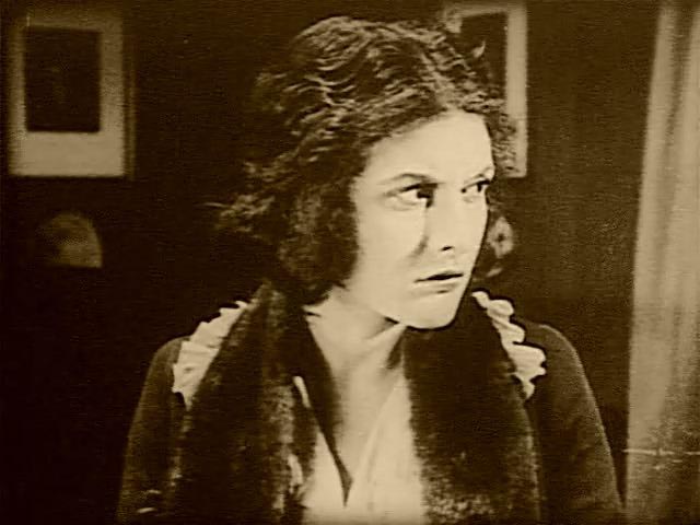 Nora (Evelyn Brent) realizes almost too late that she's in dire danger in Harry B. Parkinson's Trapped By the Mormons (1922)
