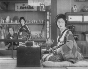 The proprietor of the gambling house glances disdainfully at the ronin in Sadao Yamanaka's Tange Sazen: The Million Ryô Pot (1935)
