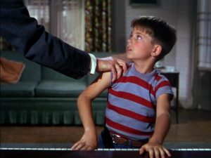 Young Bart Collins (Tommy Rettig) resists the oppression of Dr. Terwilliker (Hans Conried) in Dr. Seuss' The 5000 Fingers of Dr. T (1953)