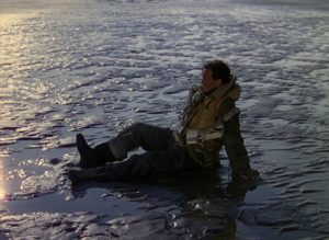 Squadron Leader Peter Carter (David Niven) wakes on a beach which may be Heaven in Michael Powell and Emeric Pressburger's A Matter of Life and Death (1946)