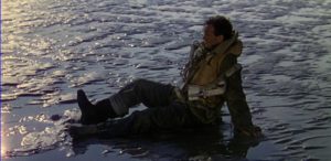 Squadron Leader Peter Carter (David Niven) wakes on a beach which may be Heaven in Michael Powell and Emeric Pressburger's A Matter of Life and Death (1946)