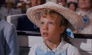 Hayley Mills as Pollyanna gradually becomes aware of the flaws of adults