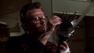 Corporate executive Bart Hughes (Peter Weller) is driven to extremes by a rodent in George Pan Cosmatos' Of Unknown Origin (1983)