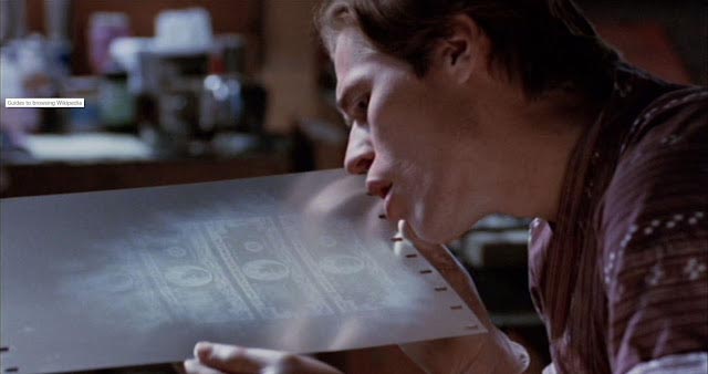 Forger Eric Masters (Willem Dafoe) examines freshly-made plates in William Friedkin's To Live and Die in L.A. (1985)