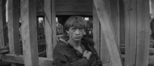 Boriska (Nikolay Burlyaev) is found alone in a village destroyed by plague in Andrei Tarkovsky's Andrei Rublev (1966)