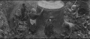 The bell is revealed as the clay mold is chipped away in Andrei Tarkovsky's Andrei Rublev (1966)