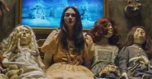 Severely abused Vera (Taylor Hickson) hides among dolls in Pascal Laugier's Incident in a Ghostland (2017)