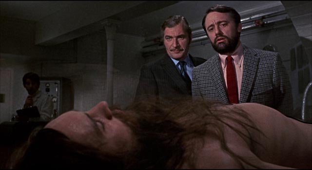 Drs. Maitland (Nigel Davenport) and Berger (Robert Vaughan) plan to wake John (Terence Stamp) from a life-long coma in Alan Cooke's The Mind of Mr. Soames (1970)