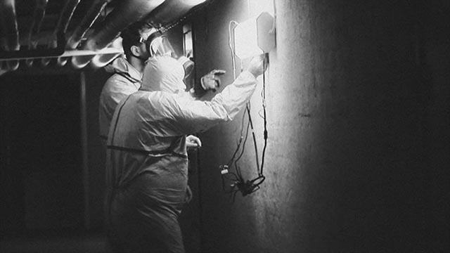 Cleaning crews work continuously to control the alien contamination in Henrik Möller's Feed the Light (2014)