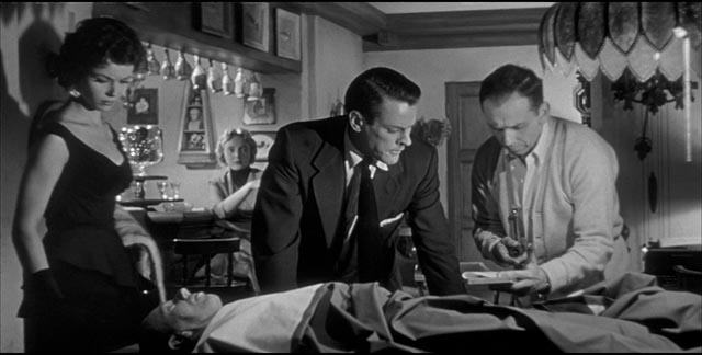 Becky (Dana Wynter), Miles (Kevin McCarthy) and Jack (King Donovan) examine the strange body in Don Siegel's Invasion of the Body Snatchers (1956)