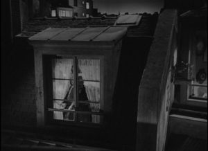 M. Hire Michel Simon) takes a voyeuristic interest in his new neighbour, Alice (Viviane Romance) in Julien Duvivier's Panique (1946)
